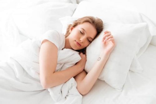sleeping young woman lies bed with eyes closed k